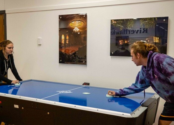 students playing air hockey